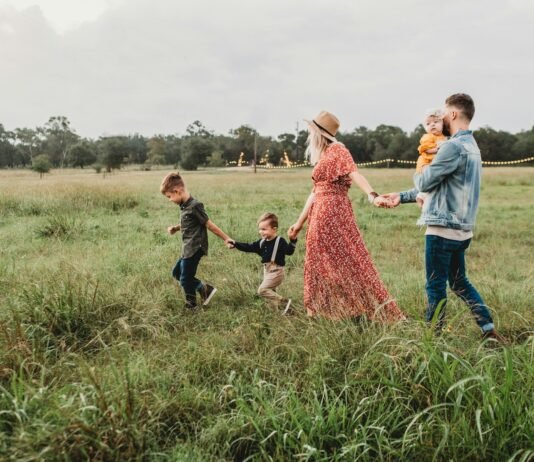 The Ties That Truly Bind: How Intentional Family Time Builds Unbreakable Bonds in a Distracted World woman holding man and toddler hands during daytime
