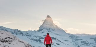 The Rhythm of Success: Building a Daily Routine That Actually Sticks person in red hoodie standing on snowy mountain during daytime