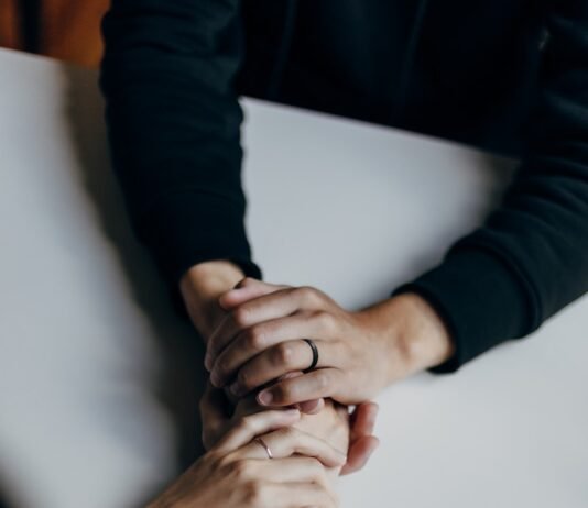 Mastering Your Inner World: Emotional Management Techniques Backed by Psychology person in black long sleeve shirt holding babys feet