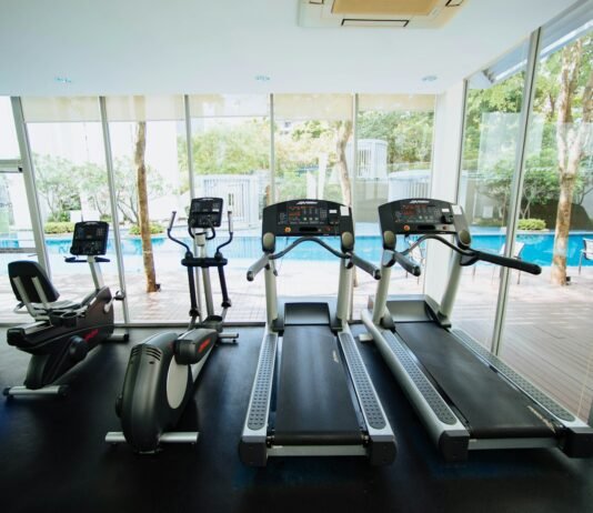 The Core of Strength: 5 Essential Exercises to Build Stability, Power, and Endurance black treadmills and elliptical trainers in glass room