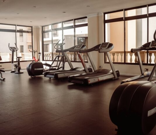 Unlocking Your Full Potential: The Power of Combining Cardio and Strength Training a gym with treadmills and exercise machines