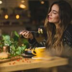More Than Roughage: Why Fiber Deserves a Front Seat in Your Diet woman holding fork in front table