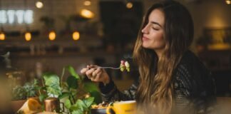 More Than Roughage: Why Fiber Deserves a Front Seat in Your Diet woman holding fork in front table