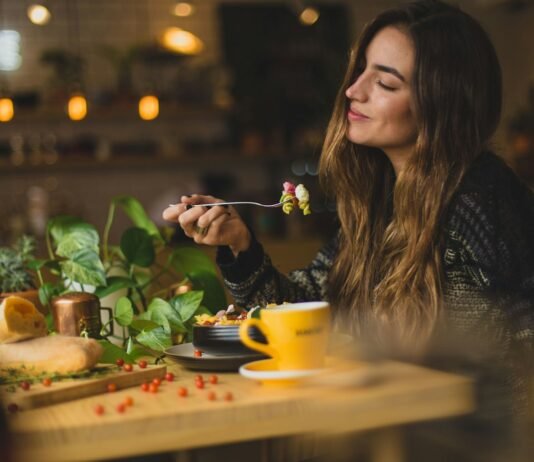 More Than Roughage: Why Fiber Deserves a Front Seat in Your Diet woman holding fork in front table