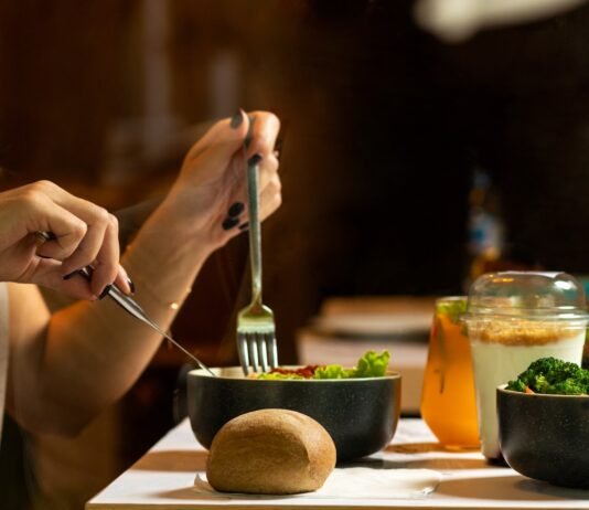 Breaking the Cycle: A Real-World Guide to Avoiding Emotional Eating Without Gimmicks or Guilt person holding silver fork and knife