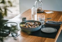 Nourish to Flourish: A Realistic Path to Eating Right and Managing Weight Naturally a wooden table topped with a bowl of food
