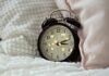 Sleepless Bites: The Surprising Foods and Drinks That Sabotage Your Sleep round black alarm clock displaying 3:12