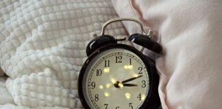 Sleepless Bites: The Surprising Foods and Drinks That Sabotage Your Sleep round black alarm clock displaying 3:12