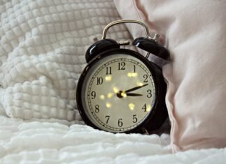 Sleepless Bites: The Surprising Foods and Drinks That Sabotage Your Sleep round black alarm clock displaying 3:12