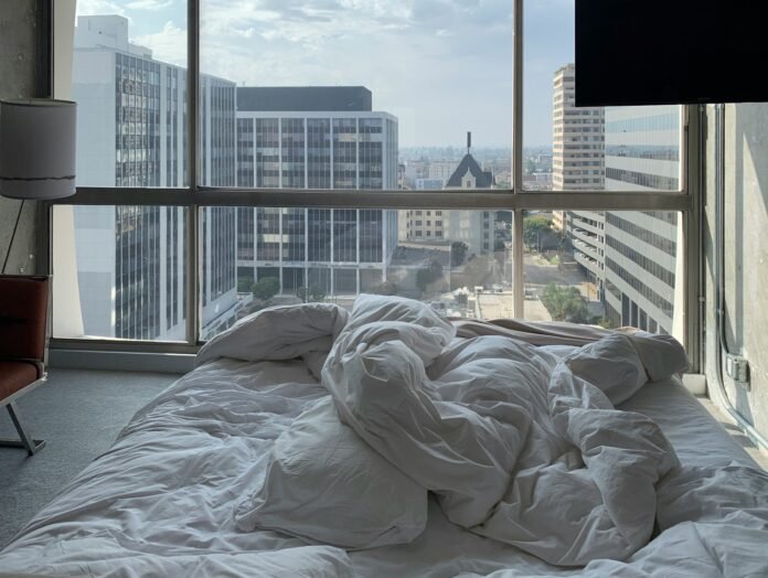 white bed linen on bed