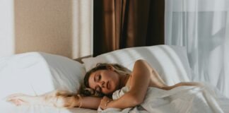 The Gentle Wind-Down: Bedtime Rituals That Actually Help You Sleep a woman lying on a bed